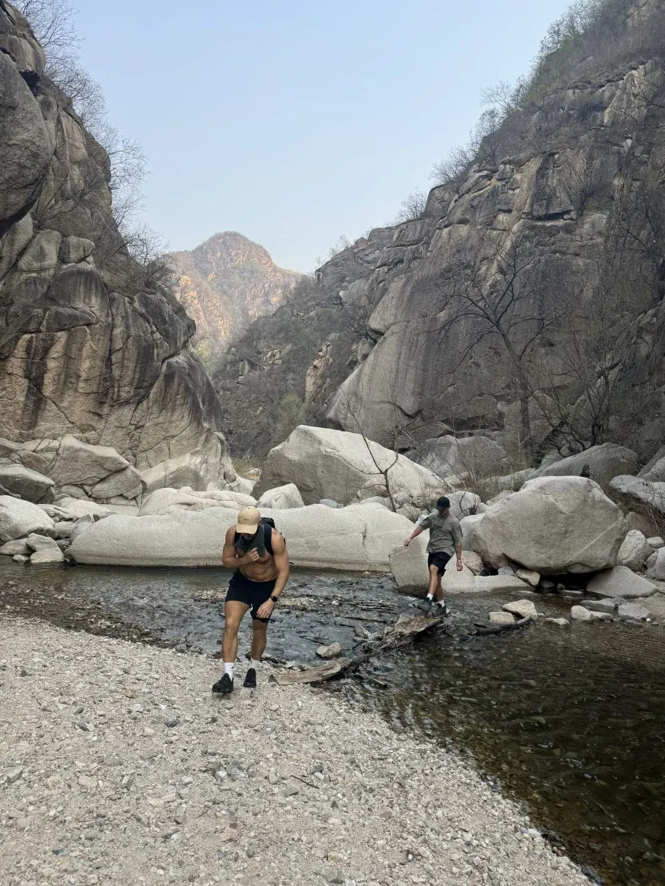 Guests hiking beside the mountain river in Miyun District
