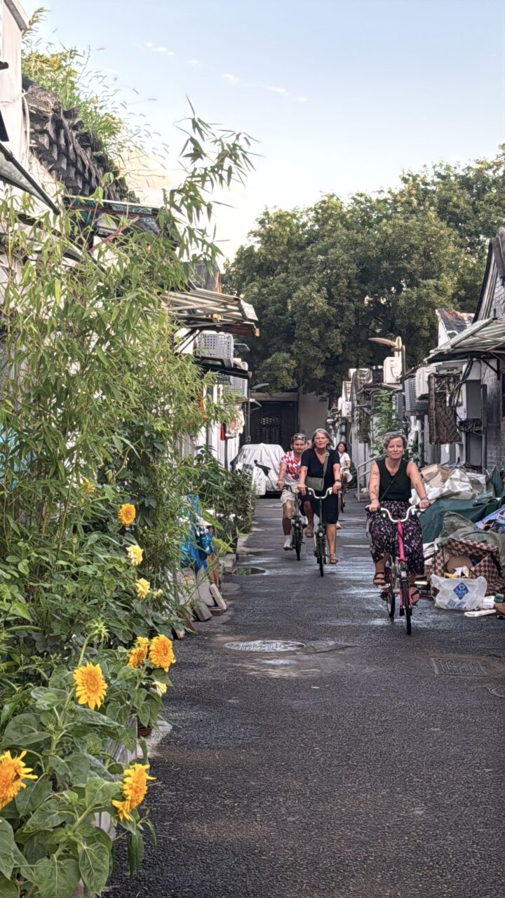 Guests riding Brompton bikes through ancient Beijing alleyways — feeling the rhythm of local time in Beijing on two wheels.