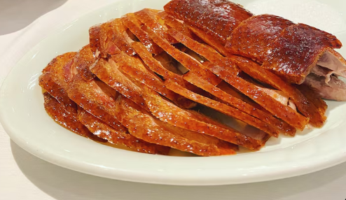 Duck restaurants in Beijing serving traditional Peking Duck with crispy skin and pancakes.